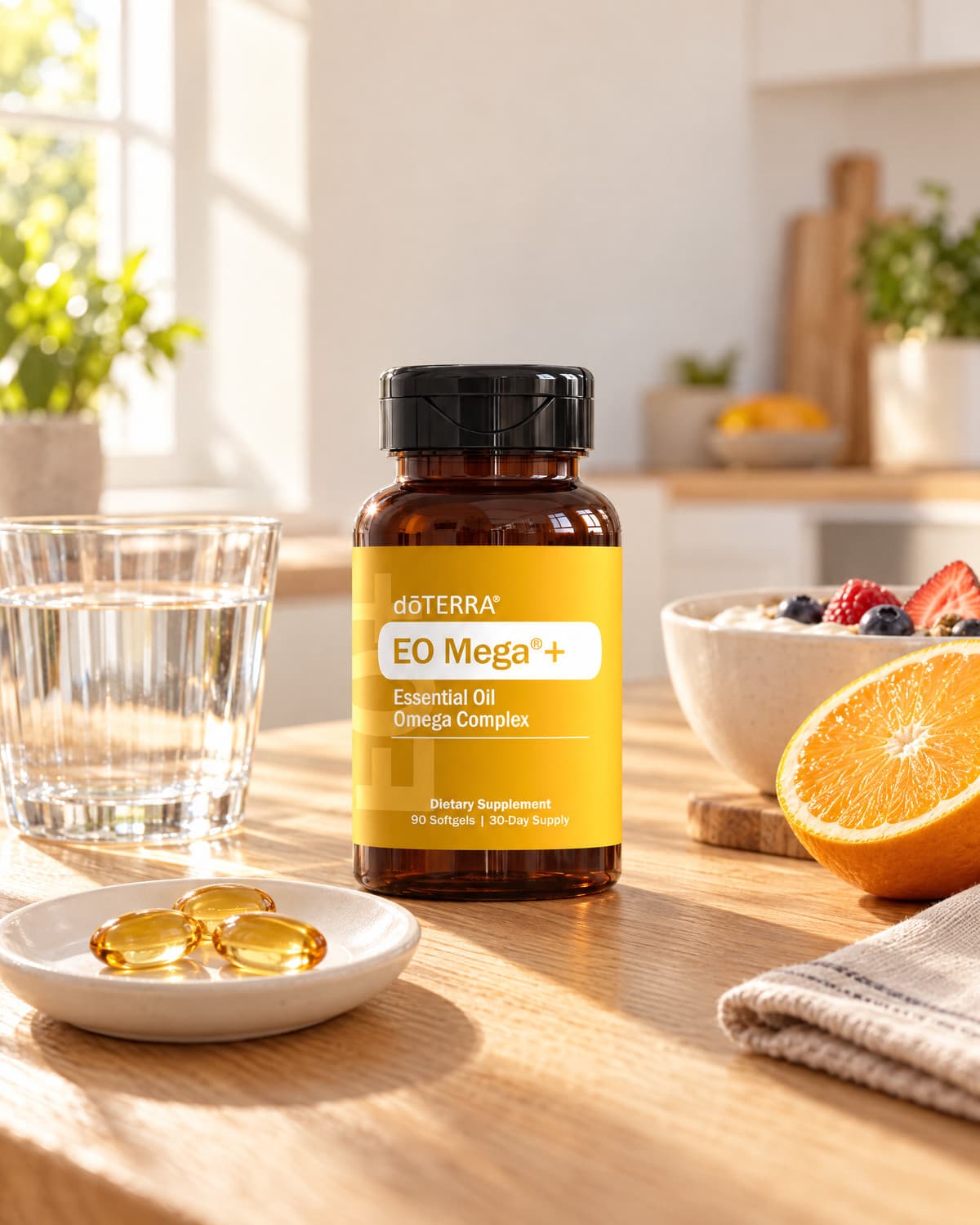 EO Mega+ bottle on a wooden table with three softgels on a small plate, a glass of water, and a halved orange